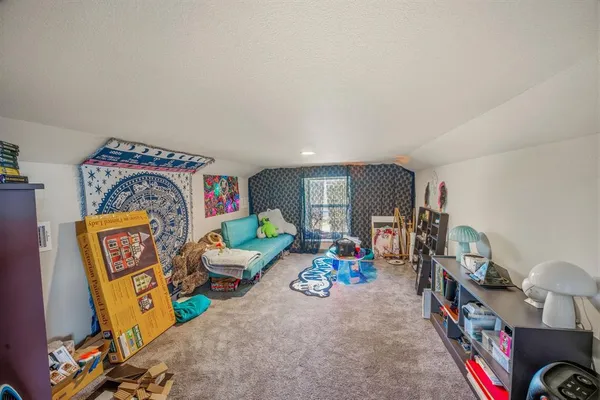 a bedroom with bed and a window