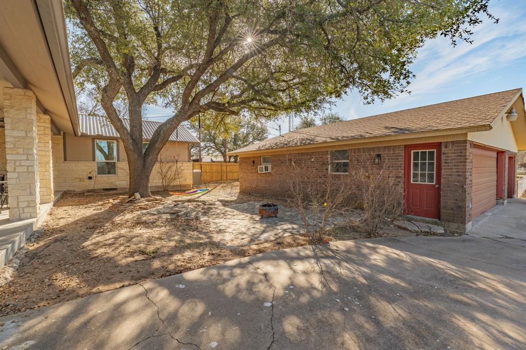 435 Edwards Drive Dublin, TX 76446 - Photo 32 of 40 a backyard of a house with large trees and outdoor space