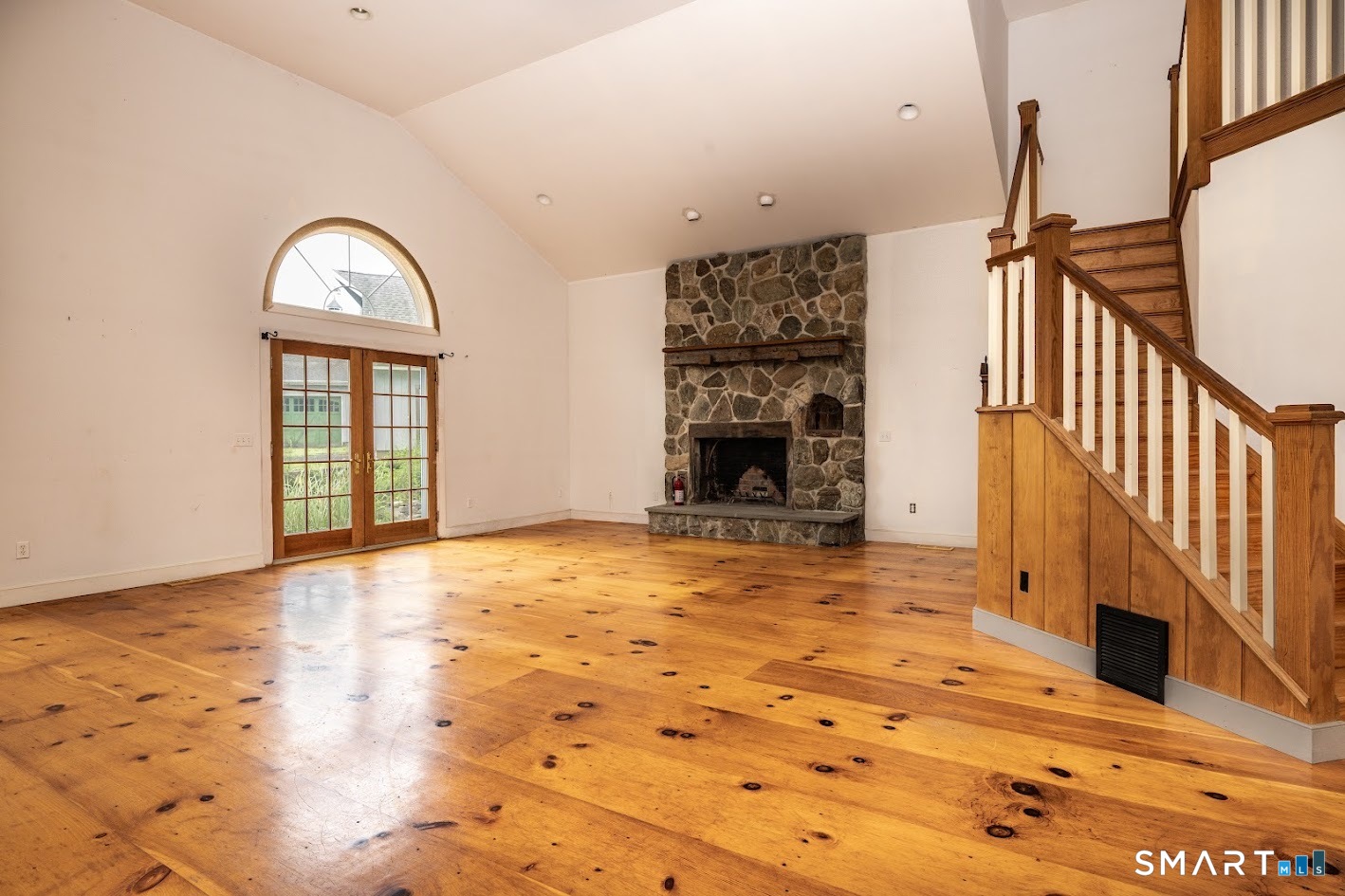 19 High Street Middlefield, CT 06455 - Photo 4 of 18 The great room showcases wide-plank floors, abundant natural light, and a stunning stone fireplace.