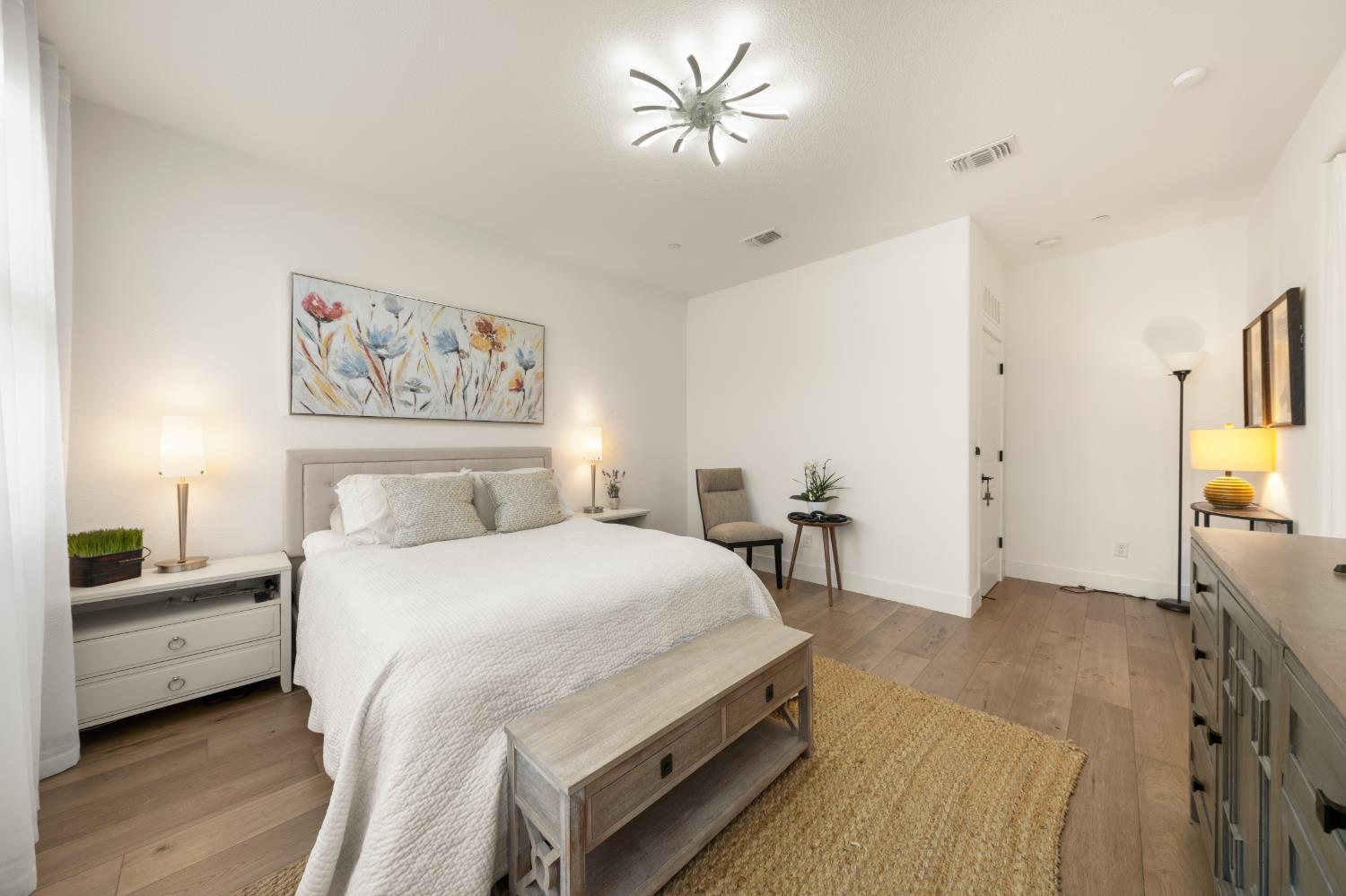 4216 Creede Way Rancho Cordova, CA 95742 - Photo 25 of 56 a bedroom with a bed and a chandelier