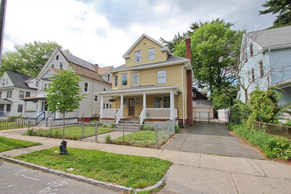 38 Virginia Street Springfield, MA 01108 - Photo 40 of 42 a front view of a house with a yard table and chairs