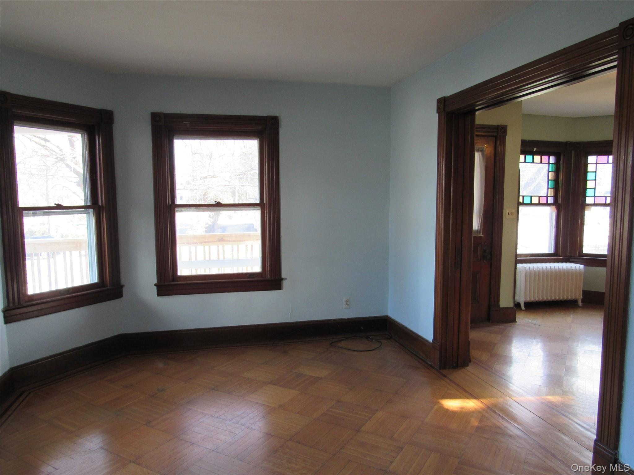 98 Main Street Chester, NY 10918 - Photo 12 of 32 Living room featuring radiator heating unit and baseboards