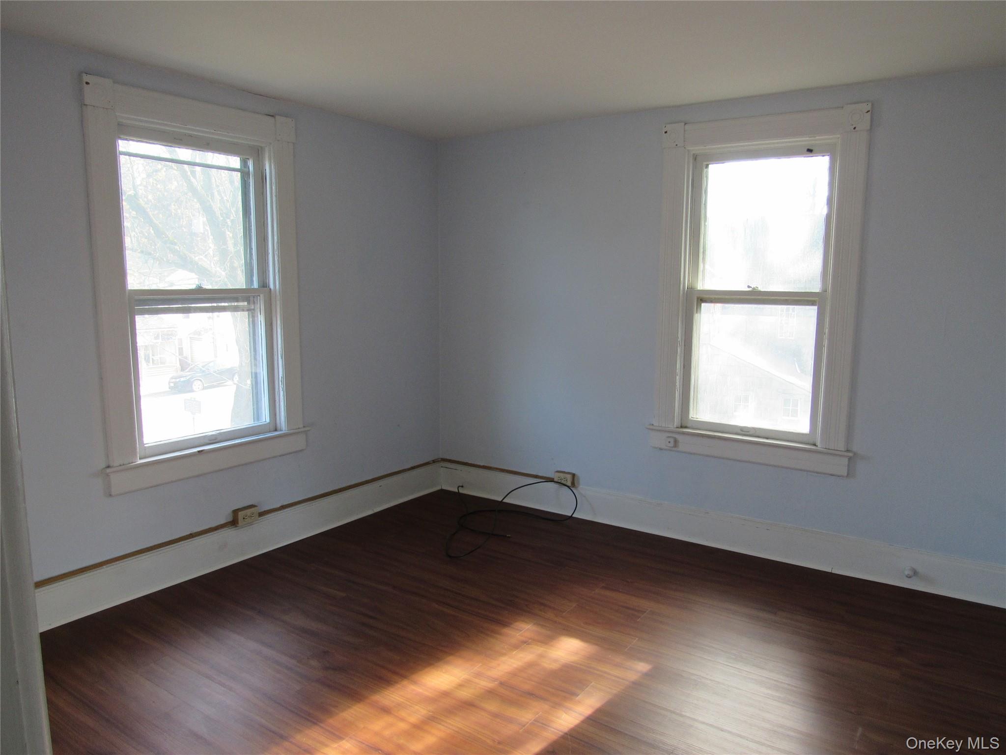 98 Main Street Chester, NY 10918 - Photo 16 of 29 an empty room with wooden floor and windows