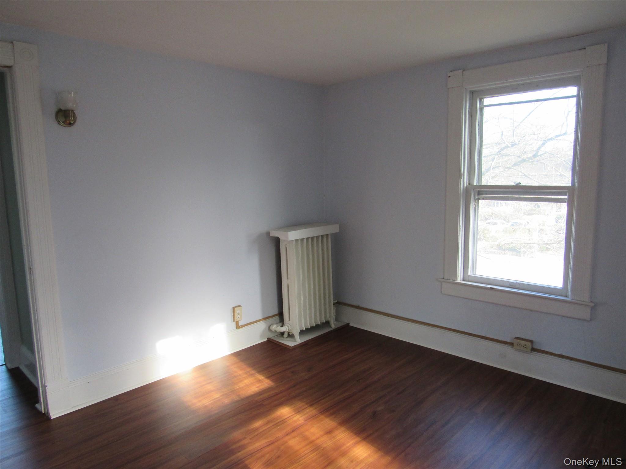 98 Main Street Chester, NY 10918 - Photo 19 of 32 Bedroom #1 featuring dark wood finished floors and radiator heating unit