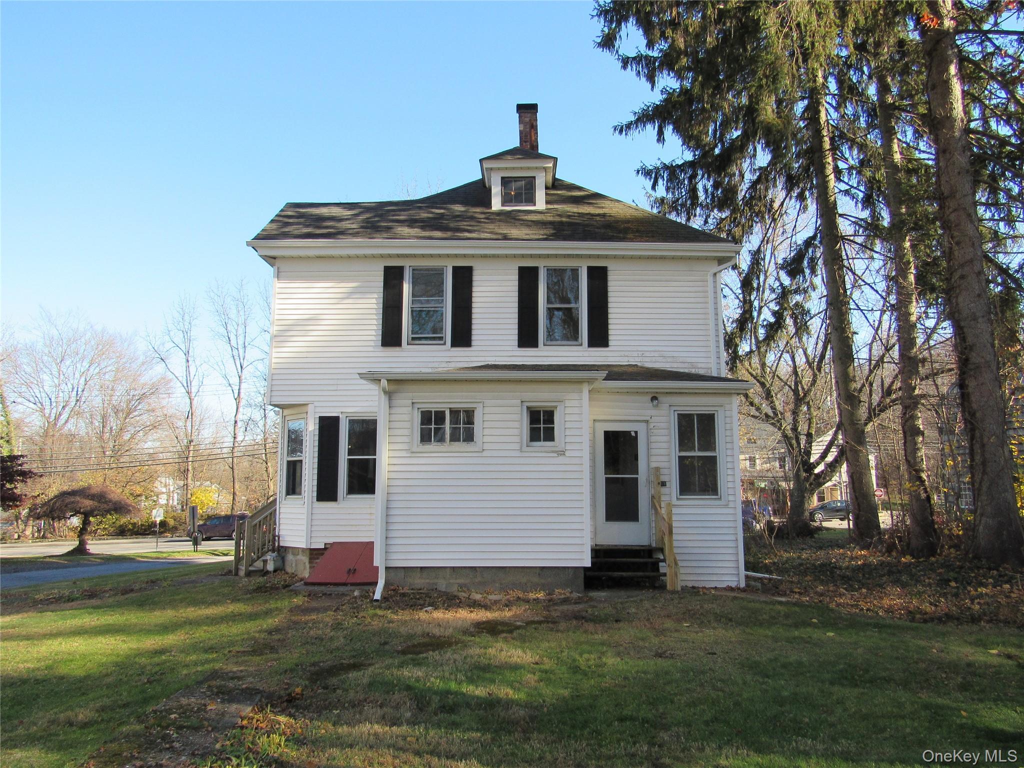 98 Main Street Chester, NY 10918 - Photo 30 of 32 Rear view of house featuring entry steps, a yard, and a chimney