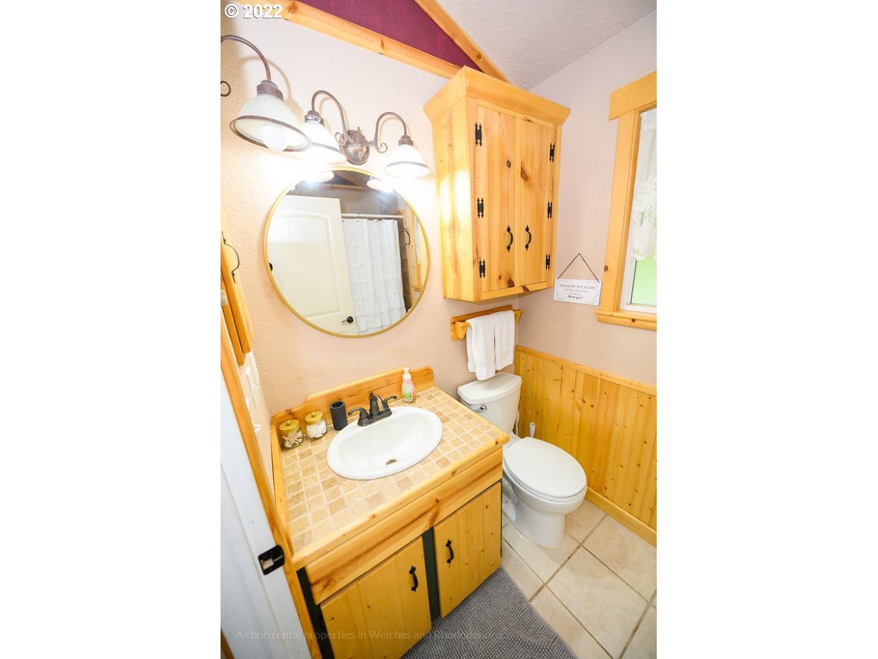 70406 East Terrace Drive Rhododendron, OR 97049 - Photo 29 of 32 a bathroom with a sink mirror and toilet