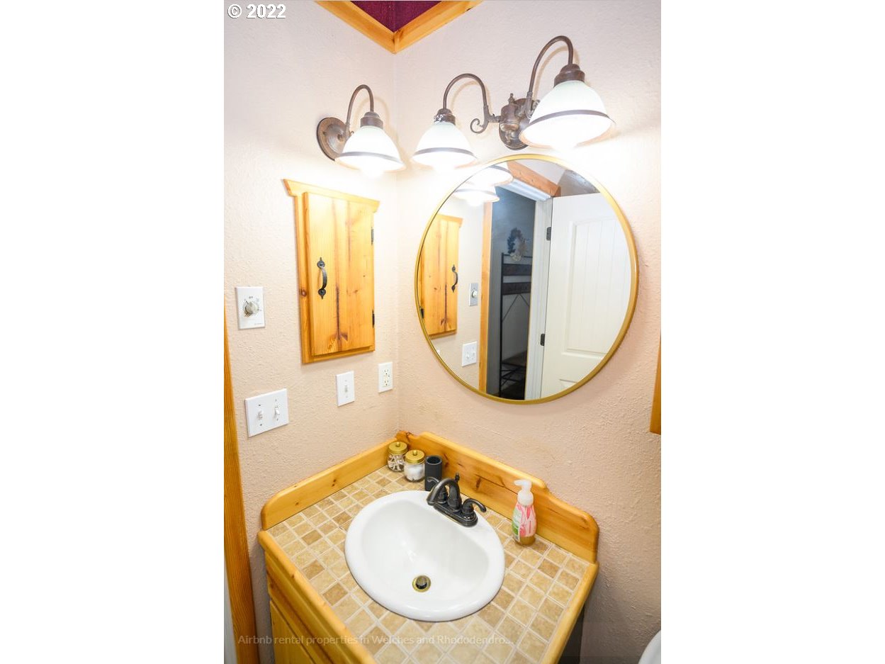 70406 East Terrace Drive Rhododendron, OR 97049 - Photo 30 of 32 a bathroom with a sink and a mirror