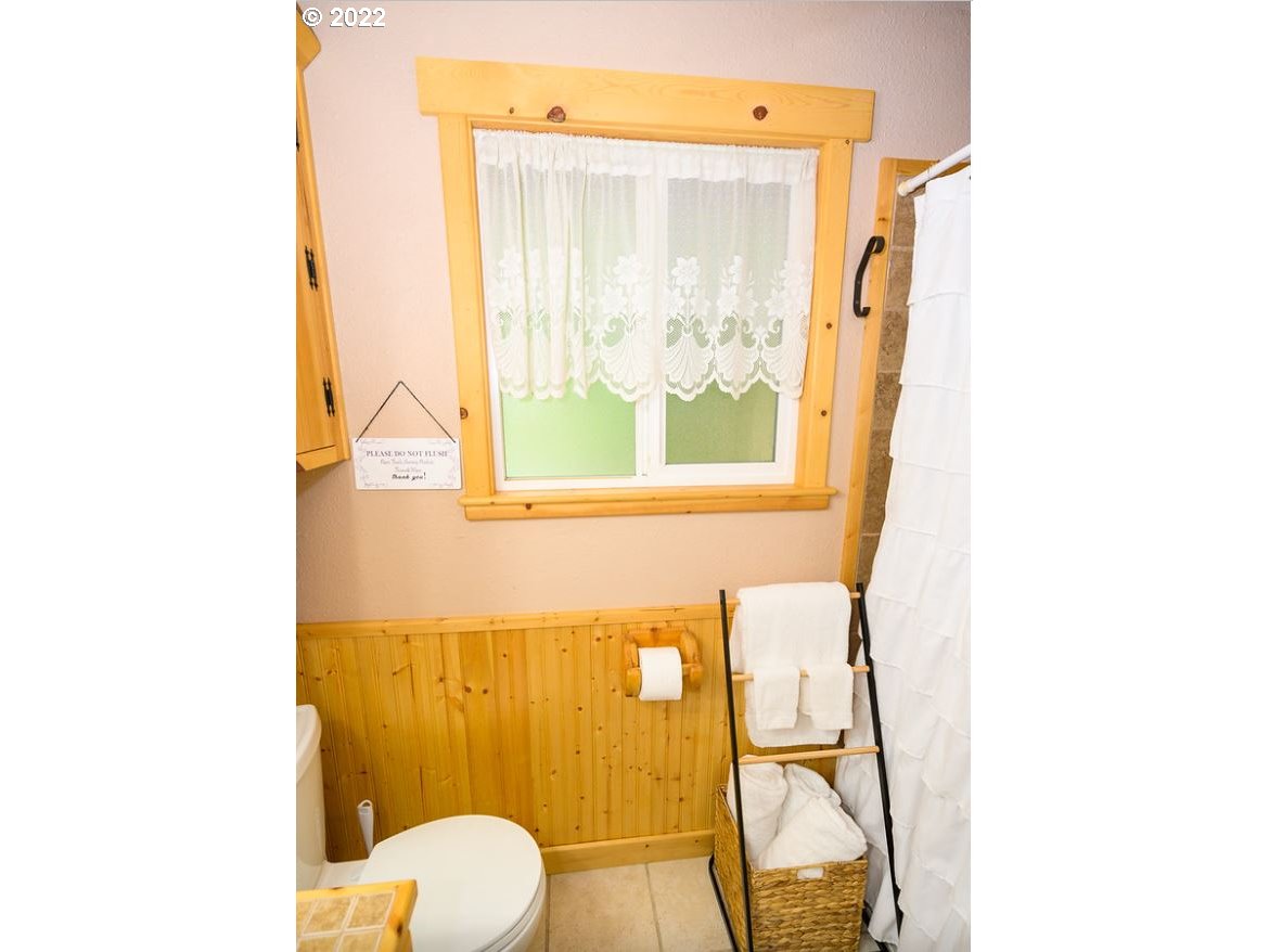 70406 East Terrace Drive Rhododendron, OR 97049 - Photo 31 of 32 a bathroom with a toilet sink and mirror