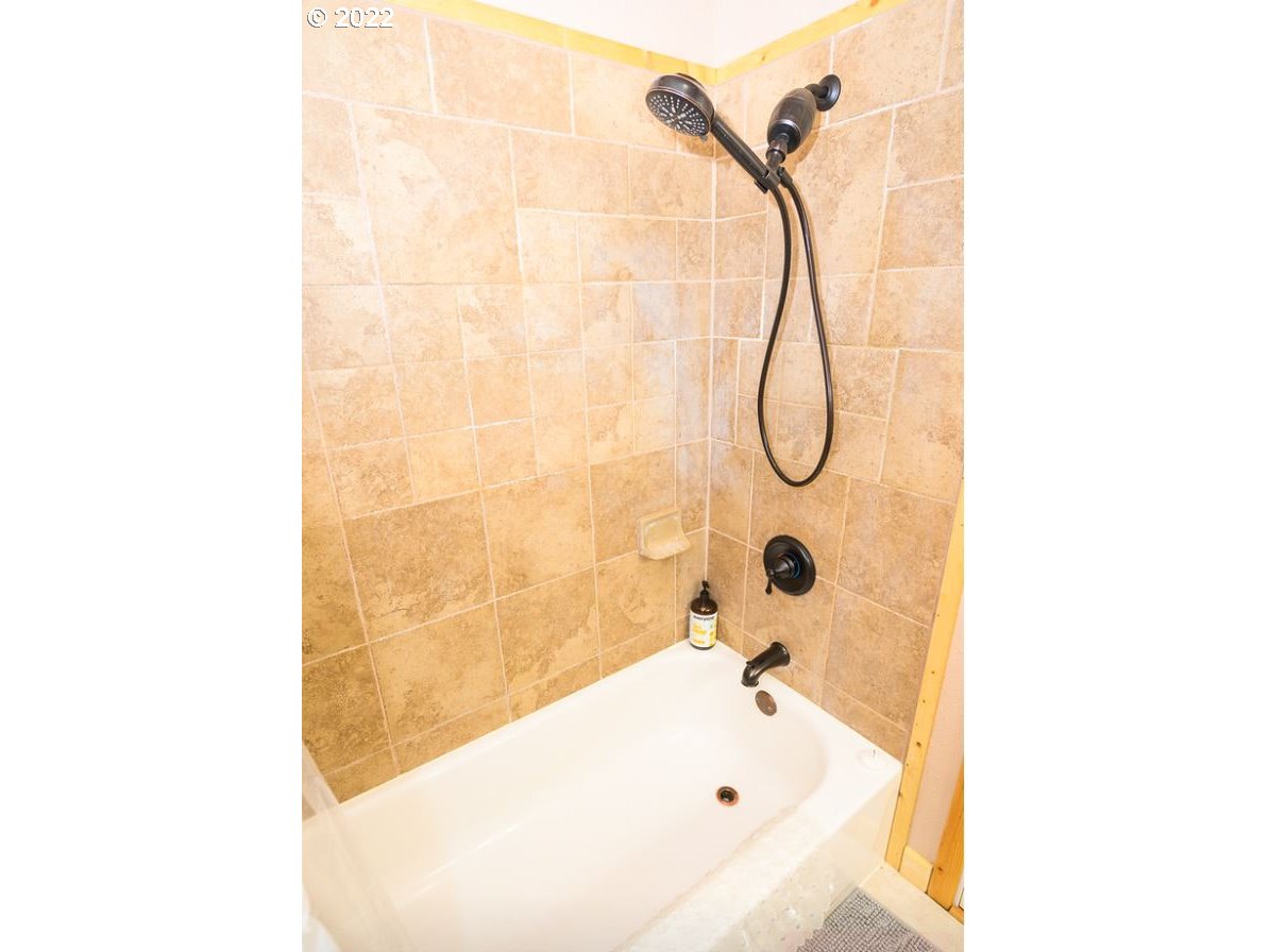 70406 East Terrace Drive Rhododendron, OR 97049 - Photo 32 of 32 a bathroom with a bath tub and shower