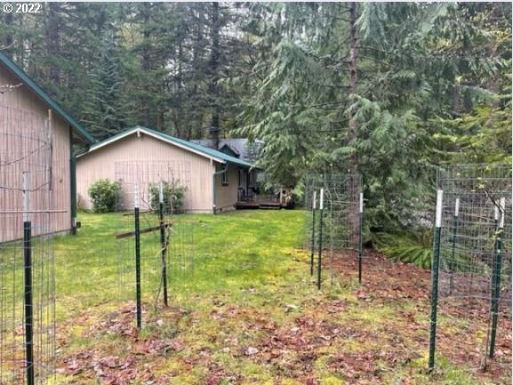 70406 East Terrace Drive Rhododendron, OR 97049 - Photo 6 of 32 a view of a house with backyard and a tree