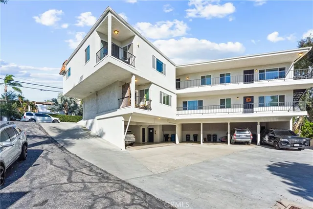 a front view of building with lot of windows and entrance