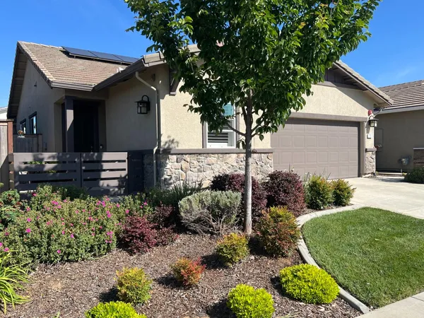 a front view of a house with garden