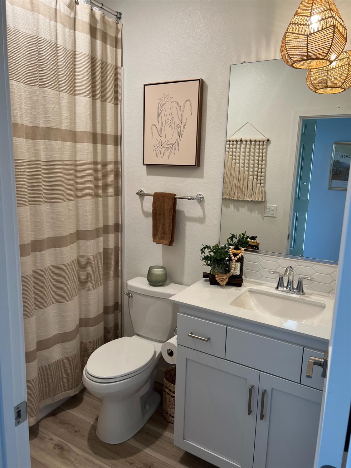 720 Riley Way Lincoln, CA 95648 - Photo 33 of 35 a bathroom with a sink a toilet and a shower curtain