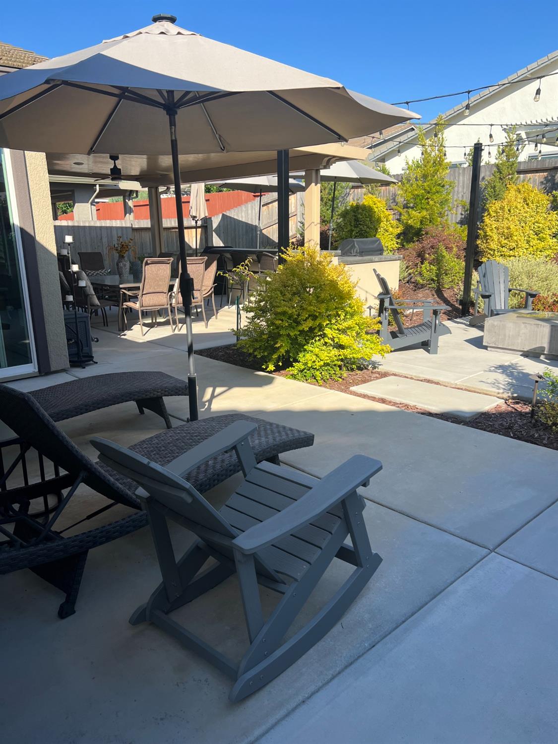 720 Riley Way Lincoln, CA 95648 - Photo 7 of 35 a view of a patio with table and chairs under an umbrella
