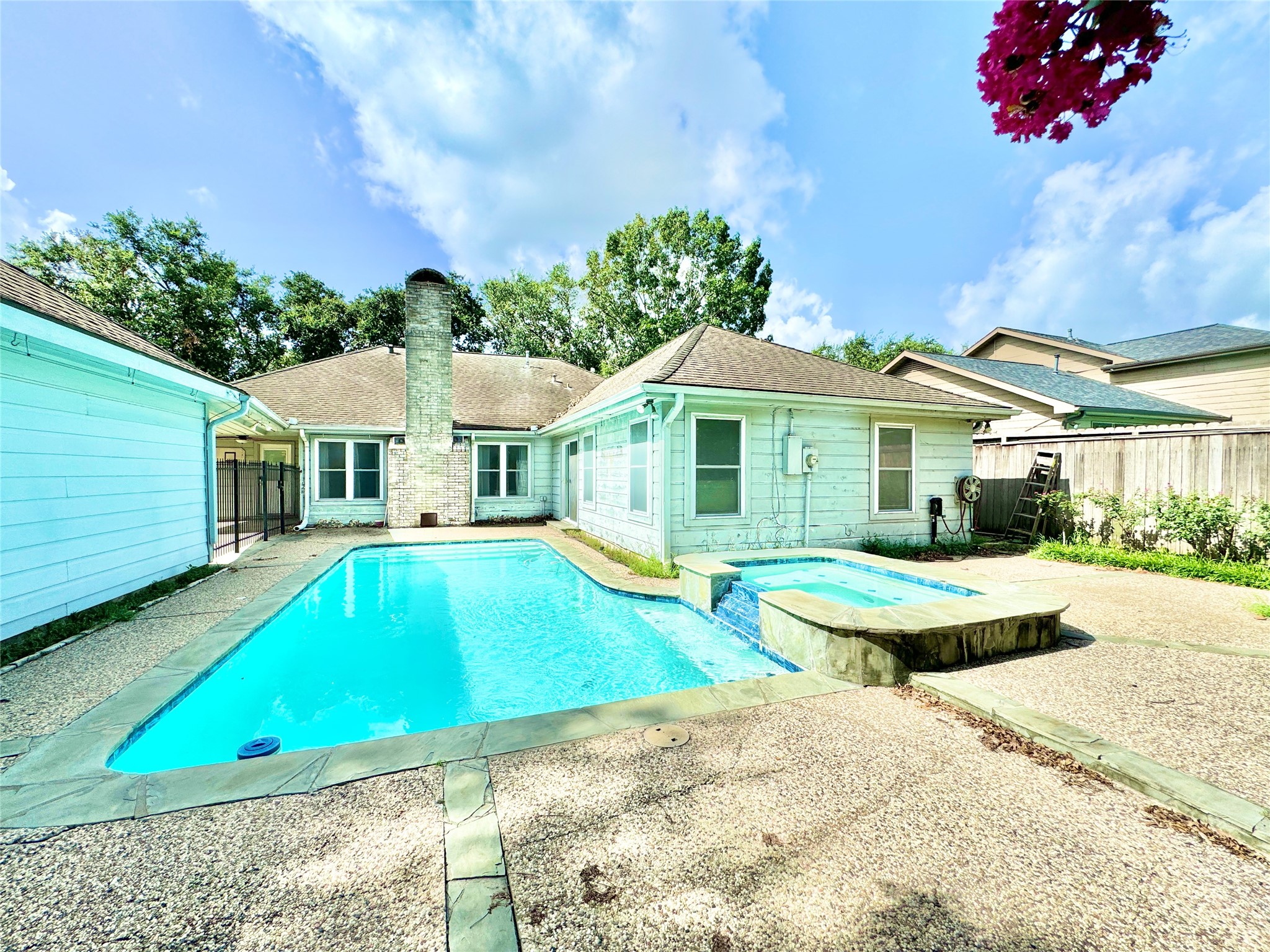 7914 Candle Lane Houston, TX 77071 - Photo 19 of 44 a front view of a house with swimming pool having outdoor seating