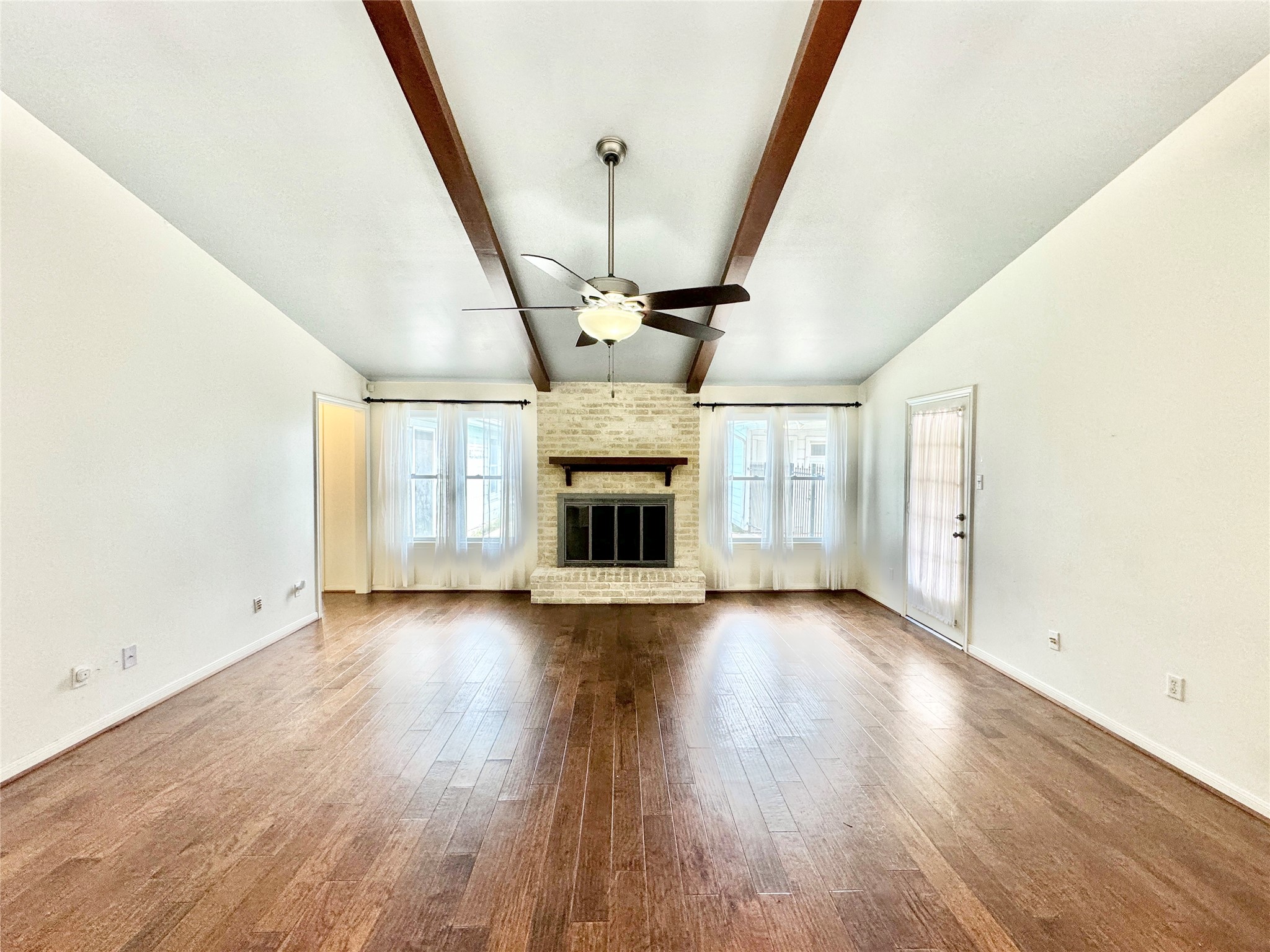 7914 Candle Lane Houston, TX 77071 - Photo 32 of 44 an empty room with wooden floor and fireplace