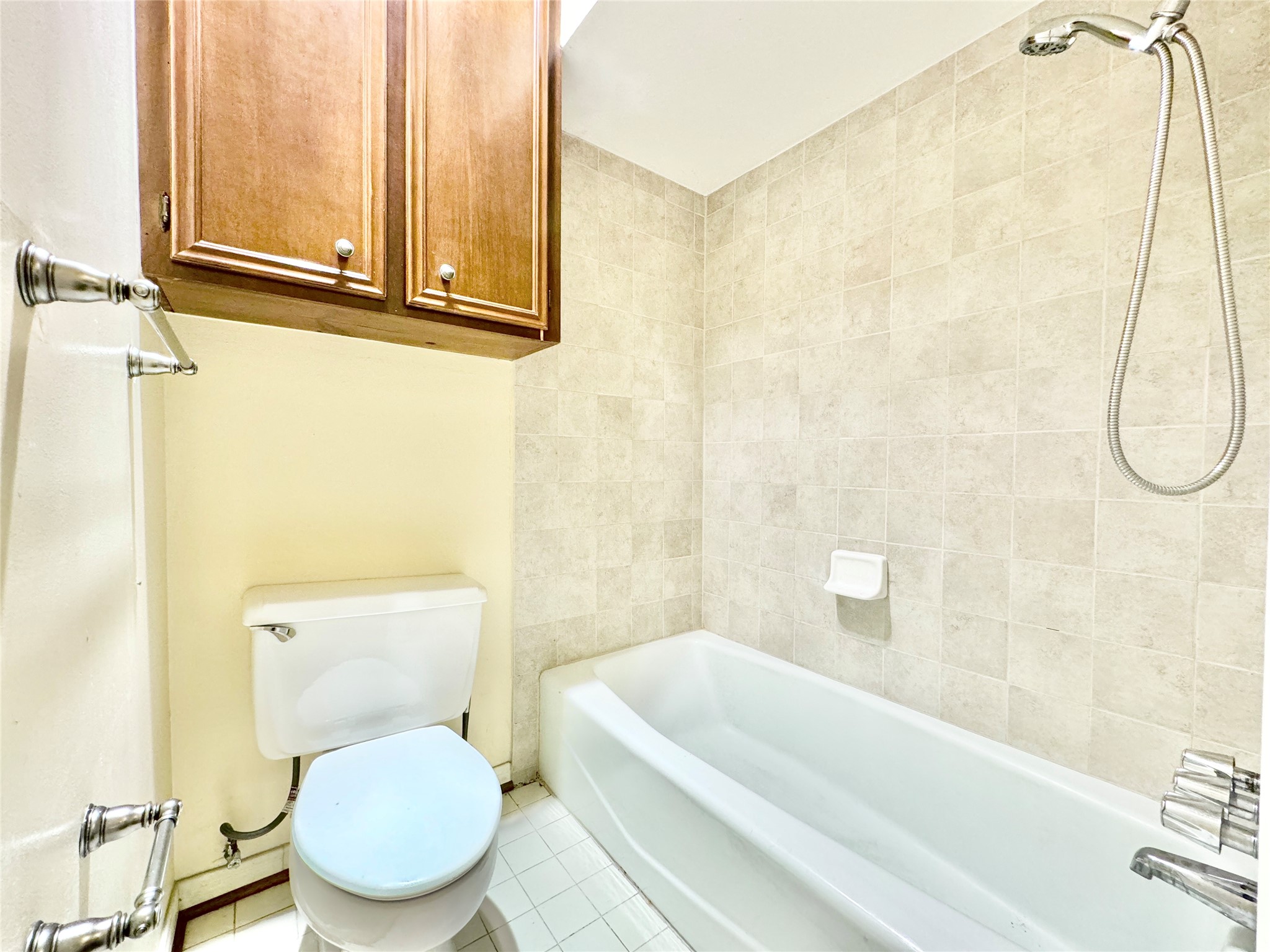7914 Candle Lane Houston, TX 77071 - Photo 44 of 44 a white toilet sitting next to a bath tub and a shower