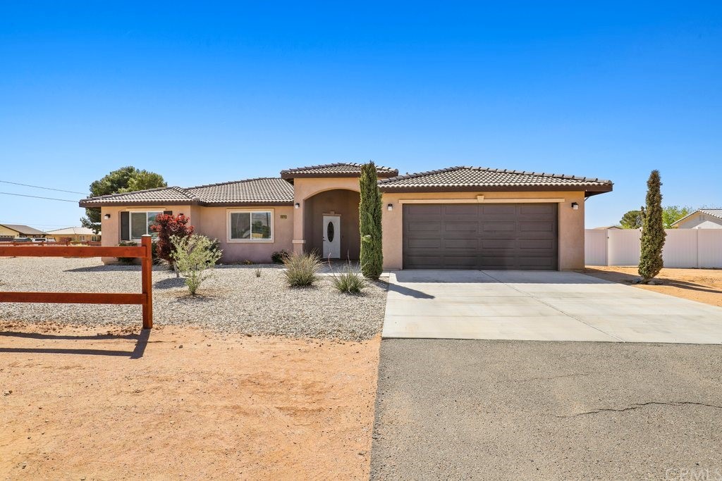 14920 Tonikan Road Apple Valley, CA 92307 - Photo 1 of 1 a front view of a house with a yard
