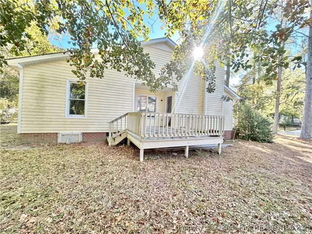 a view of a room with a ceiling fan and a window