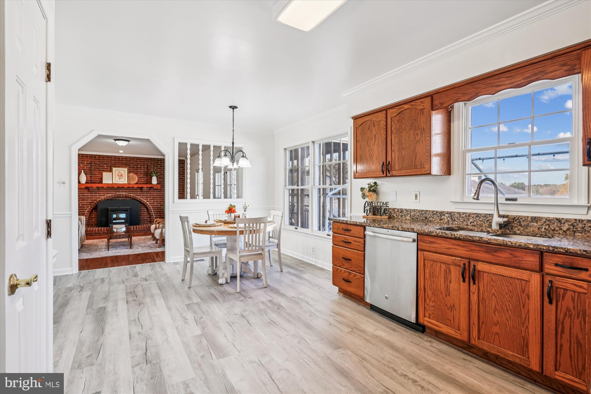 7951 Olivers Shop Road La Plata, MD 20646 - Photo 11 of 32 a kitchen with stainless steel appliances granite countertop a stove a sink dishwasher and a dining table with wooden cabinet