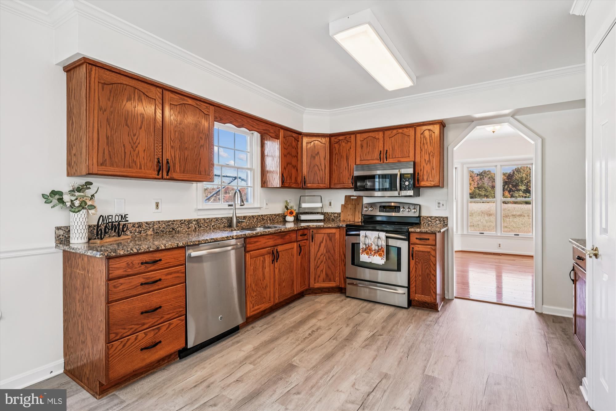 7951 Olivers Shop Road La Plata, MD 20646 - Photo 13 of 32 a kitchen with granite countertop wooden floors stainless steel appliances and a counter space