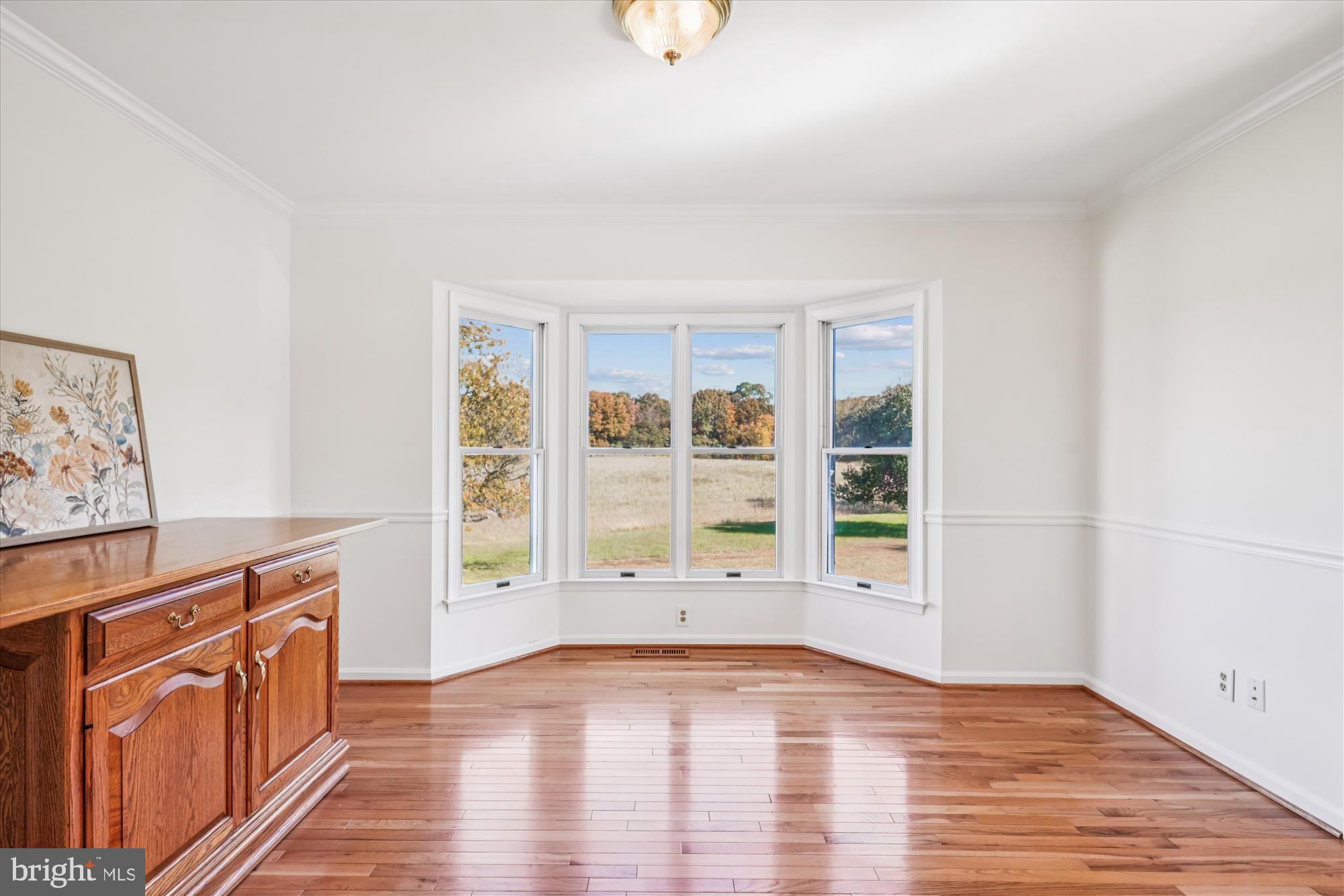 7951 Olivers Shop Road La Plata, MD 20646 - Photo 14 of 32 an empty room with wooden floor and windows