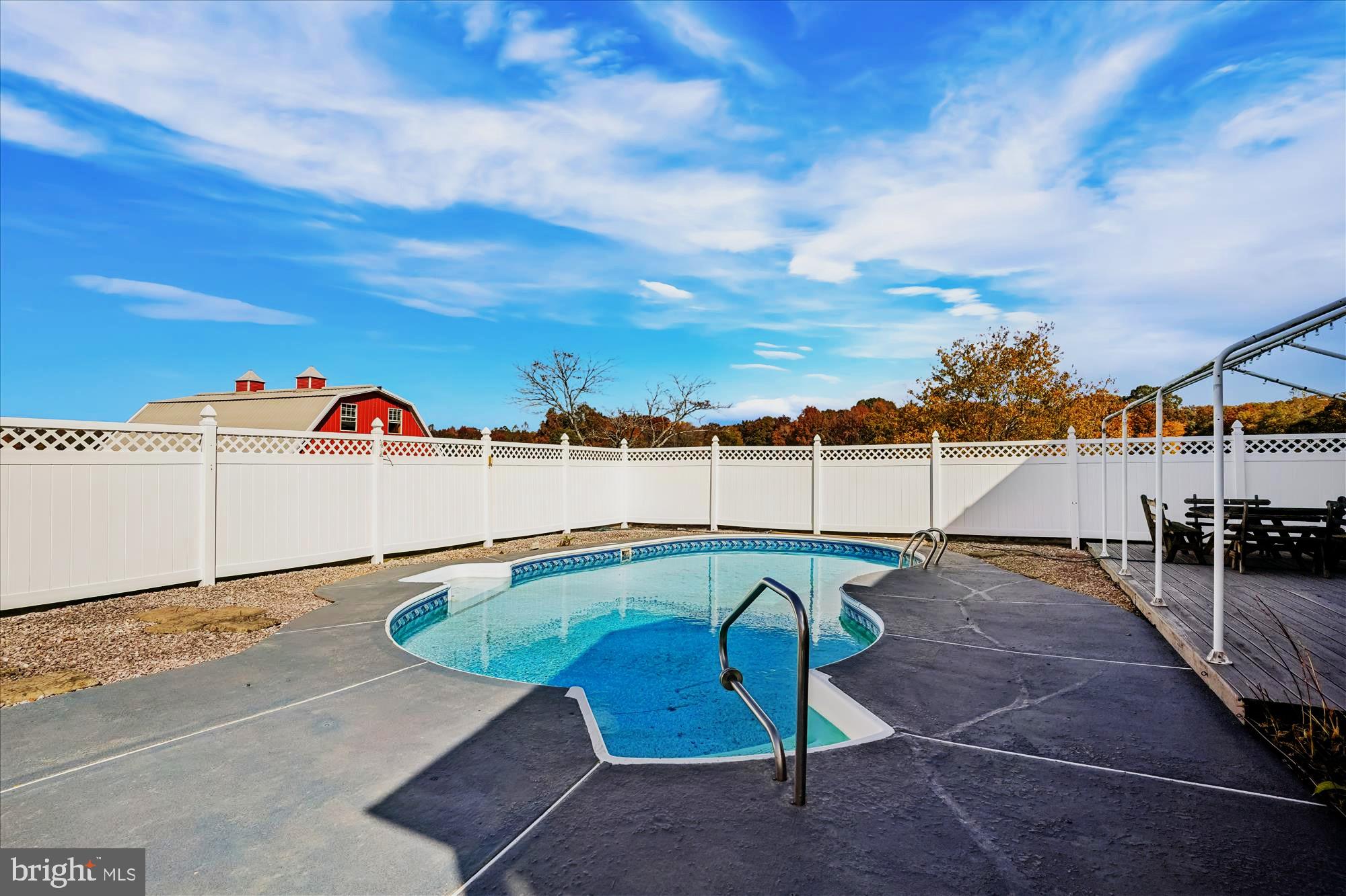 7951 Olivers Shop Road La Plata, MD 20646 - Photo 3 of 32 a view of a swimming pool with a chair and tables in the back yard