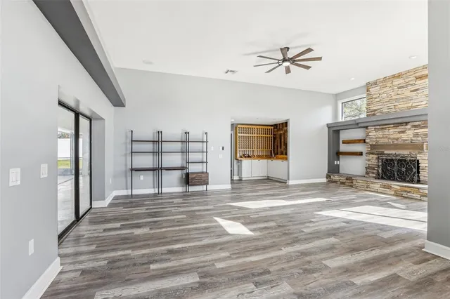 a kitchen with stainless steel appliances granite countertop a kitchen island a stove a sink and a refrigerator