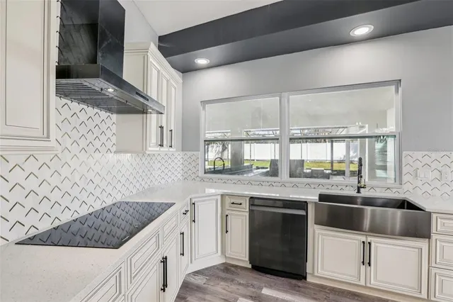 a view of a kitchen with white cabinets