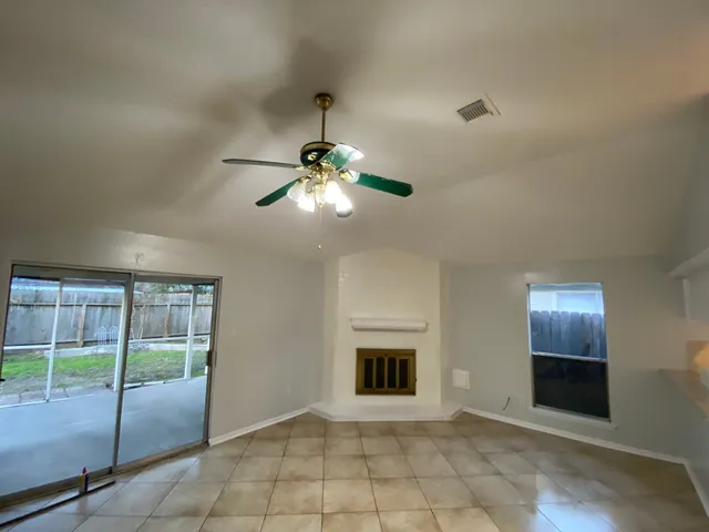 a view of an empty room with glass door