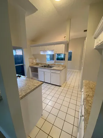 a kitchen with a stove a refrigerator and a sink