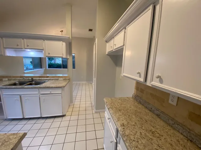 a kitchen with stainless steel appliances granite countertop a sink and cabinets