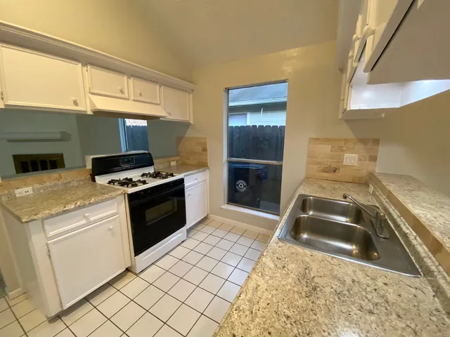 a view of a hallway with wooden floor and chandelier