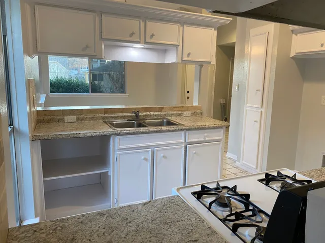 a kitchen with a stove and a refrigerator