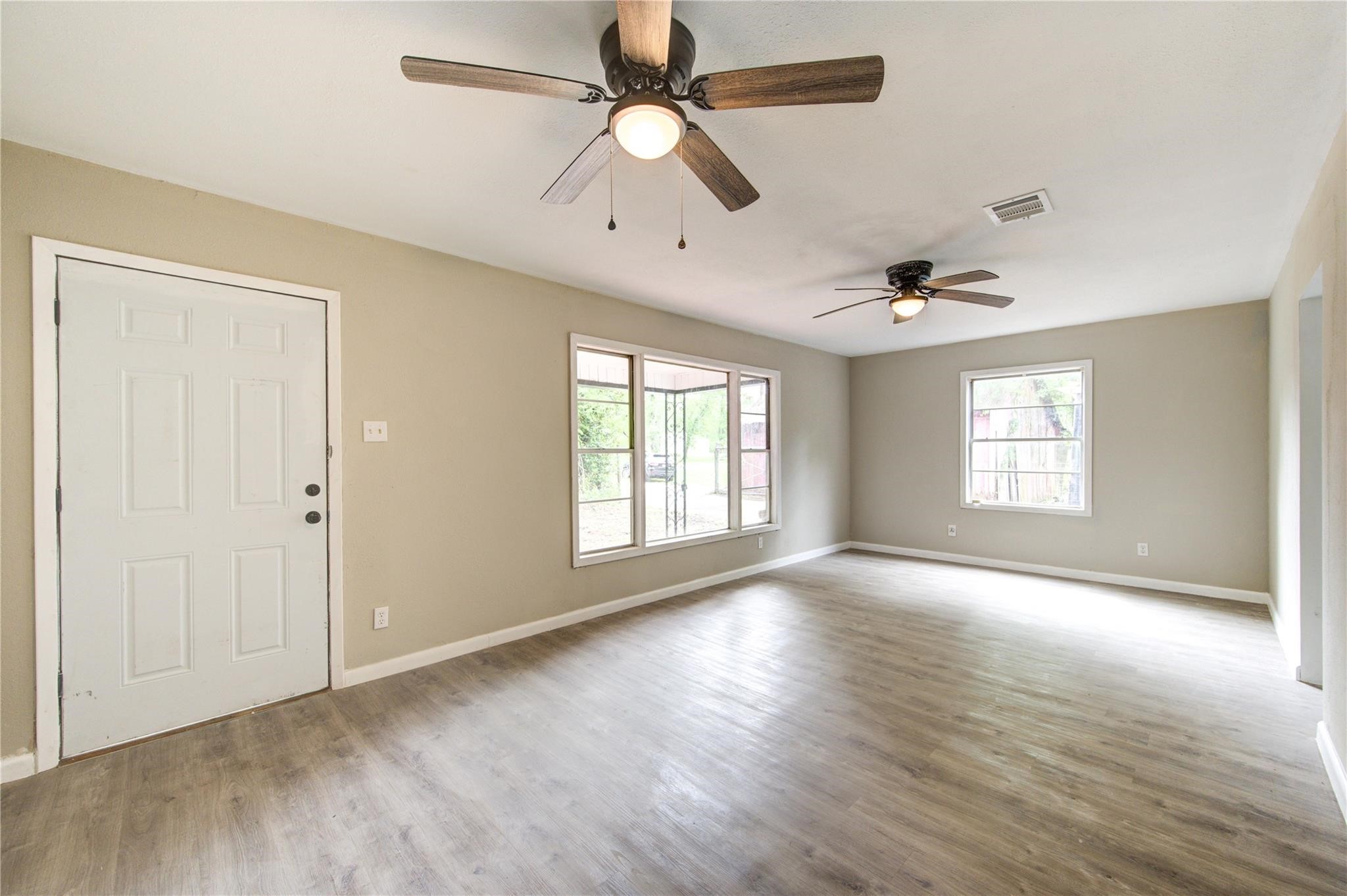 808 State Highway Loop Goodrich, TX 77335 - Photo 13 of 45 a view of an empty room with window and wooden floor