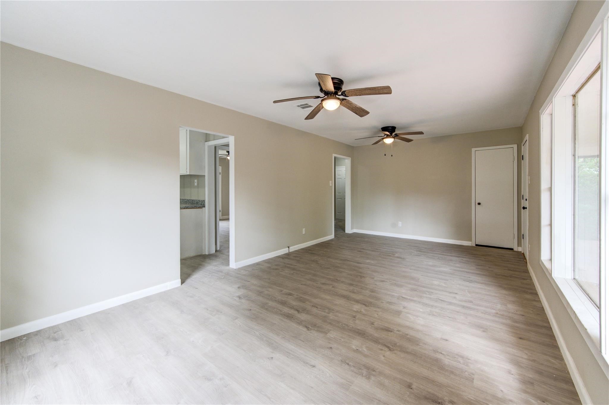 808 State Highway Loop Goodrich, TX 77335 - Photo 18 of 45 a view of empty room with wooden floor and ceiling fan