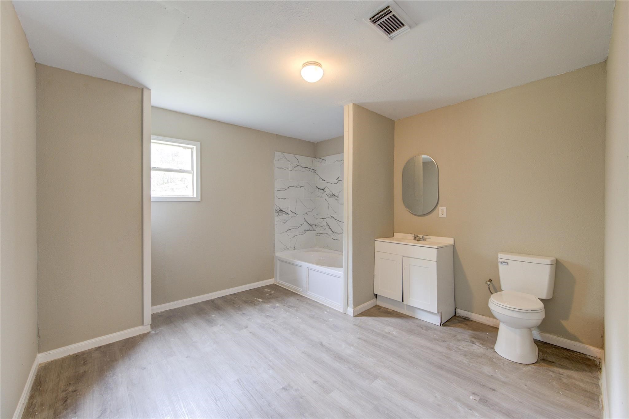 808 State Highway Loop Goodrich, TX 77335 - Photo 27 of 45 a view of a bathroom with toilet a sink and a mirror
