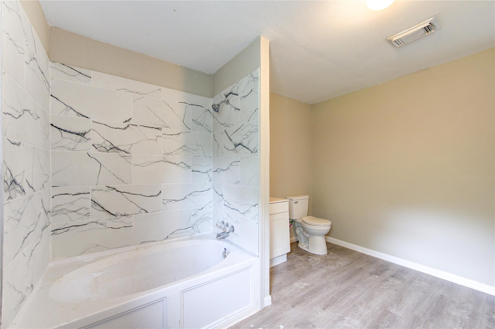 808 State Highway Loop Goodrich, TX 77335 - Photo 29 of 45 a bathroom with a bathtub and a toilet