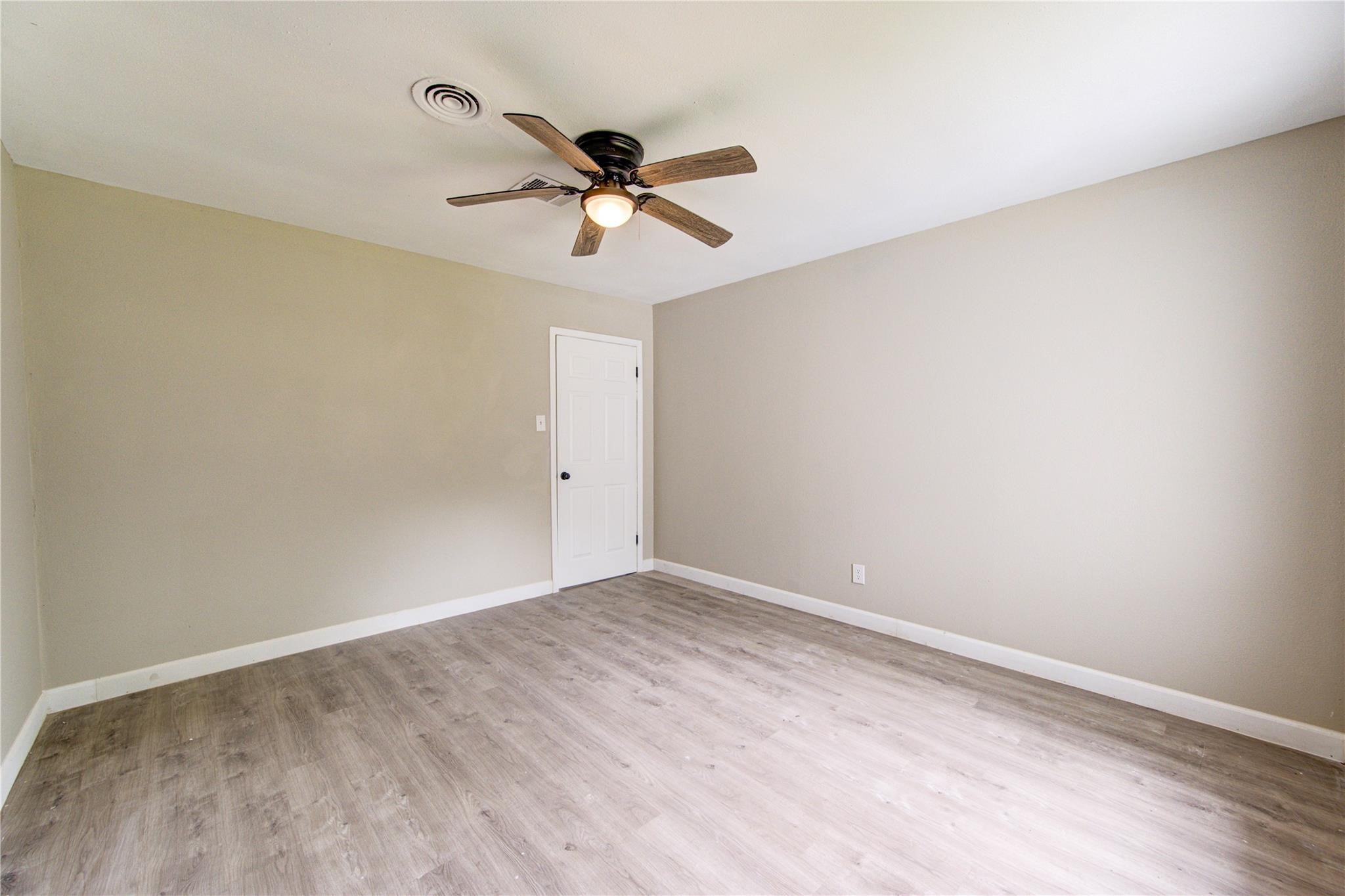 808 State Highway Loop Goodrich, TX 77335 - Photo 30 of 45 an empty room with a window and a fan