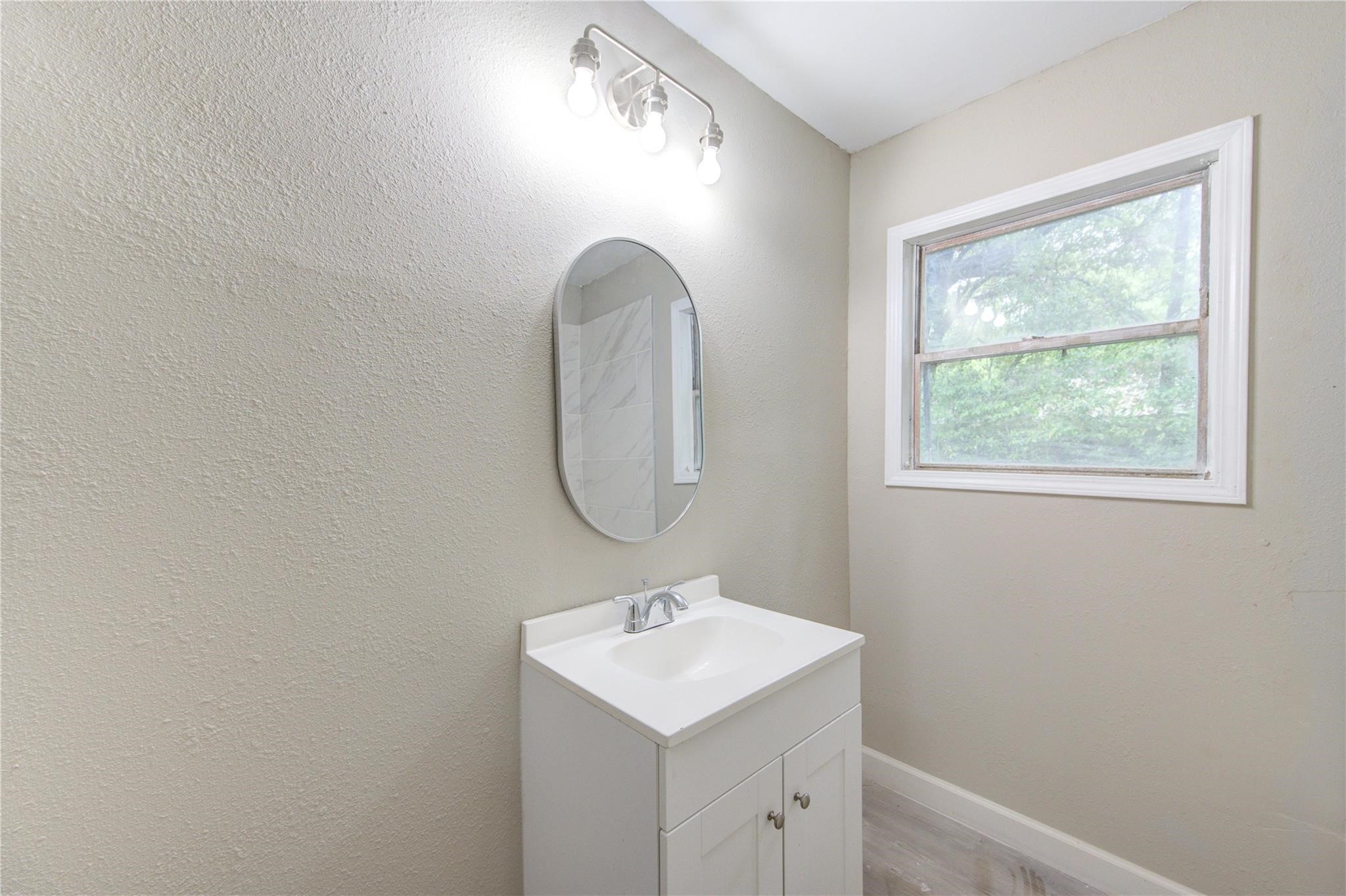 808 State Highway Loop Goodrich, TX 77335 - Photo 34 of 45 a bathroom with a sink and a mirror
