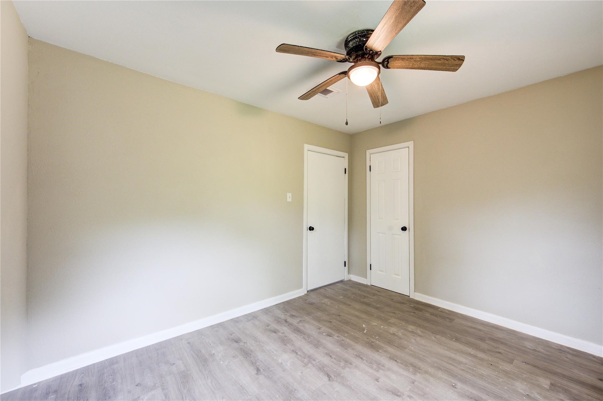 808 State Highway Loop Goodrich, TX 77335 - Photo 38 of 45 a view of room with a ceiling fan and wooden floor
