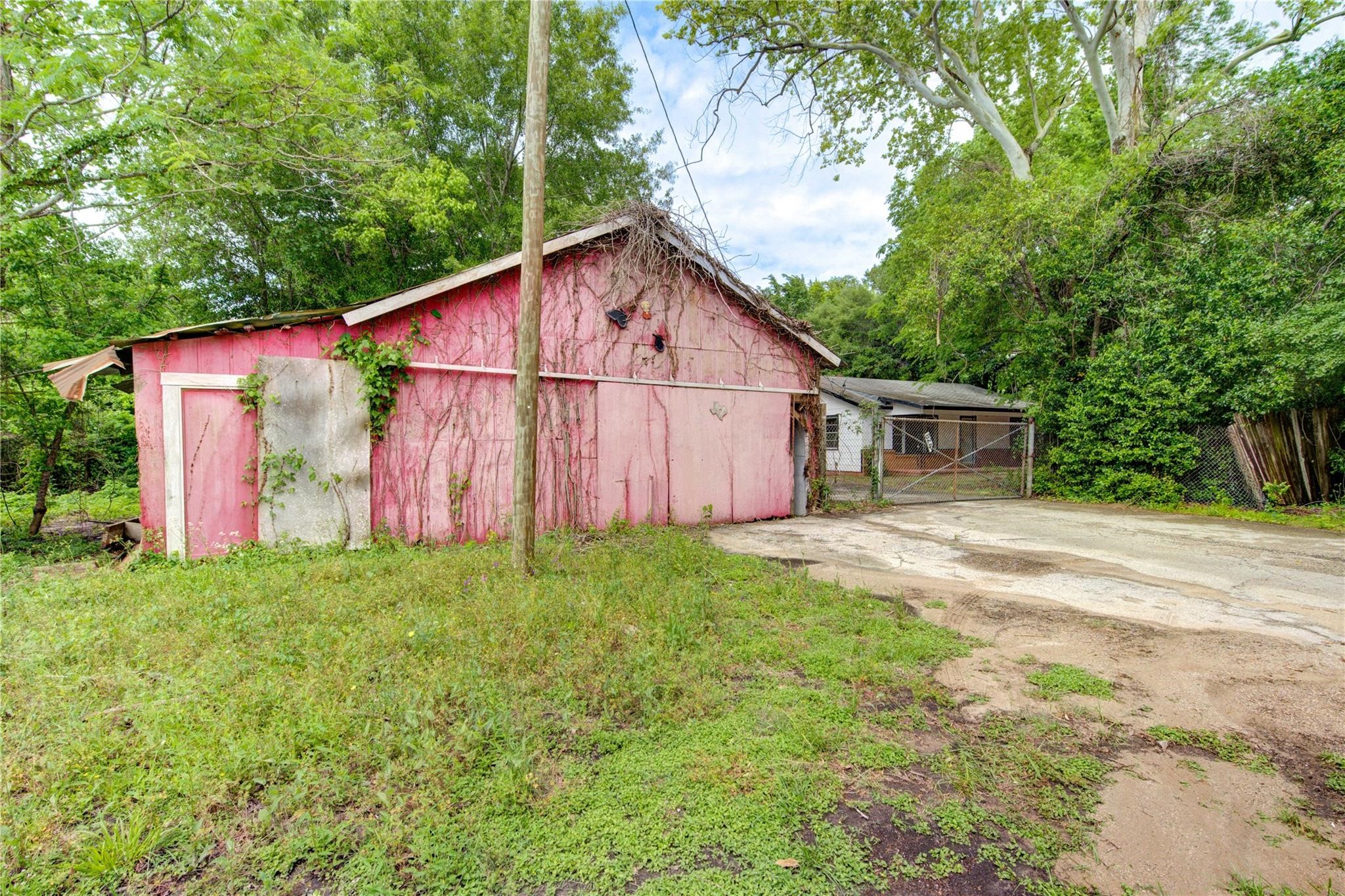 808 State Highway Loop Goodrich, TX 77335 - Photo 39 of 45 a view of a backyard with barn and large trees