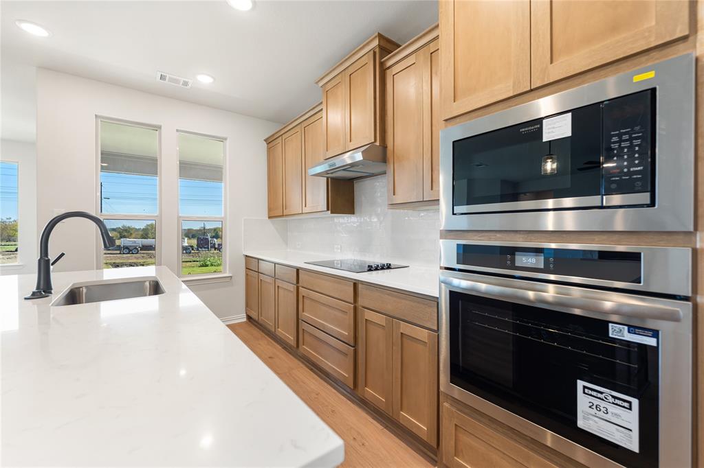 30 Roosevelt Ln Valley View Valley View, TX 76272 - Photo 20 of 35 a kitchen with stainless steel appliances a stove microwave and sink