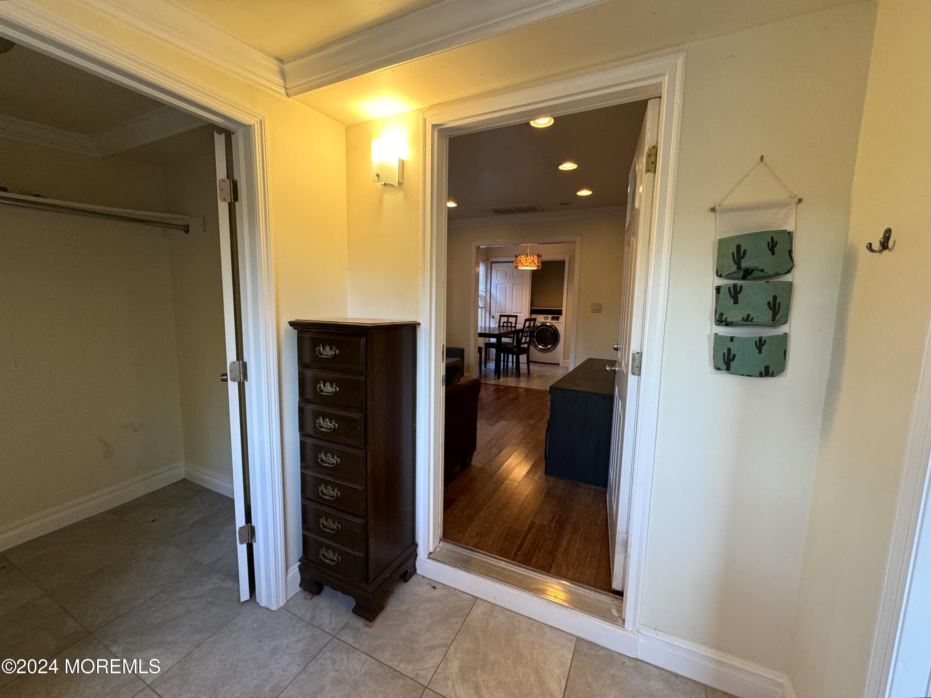 340 Elberon Boulevard, Unit REAR HOUSE Oakhurst, NJ 07755 - Photo 2 of 5 a view of a hallway and a livingroom with furniture