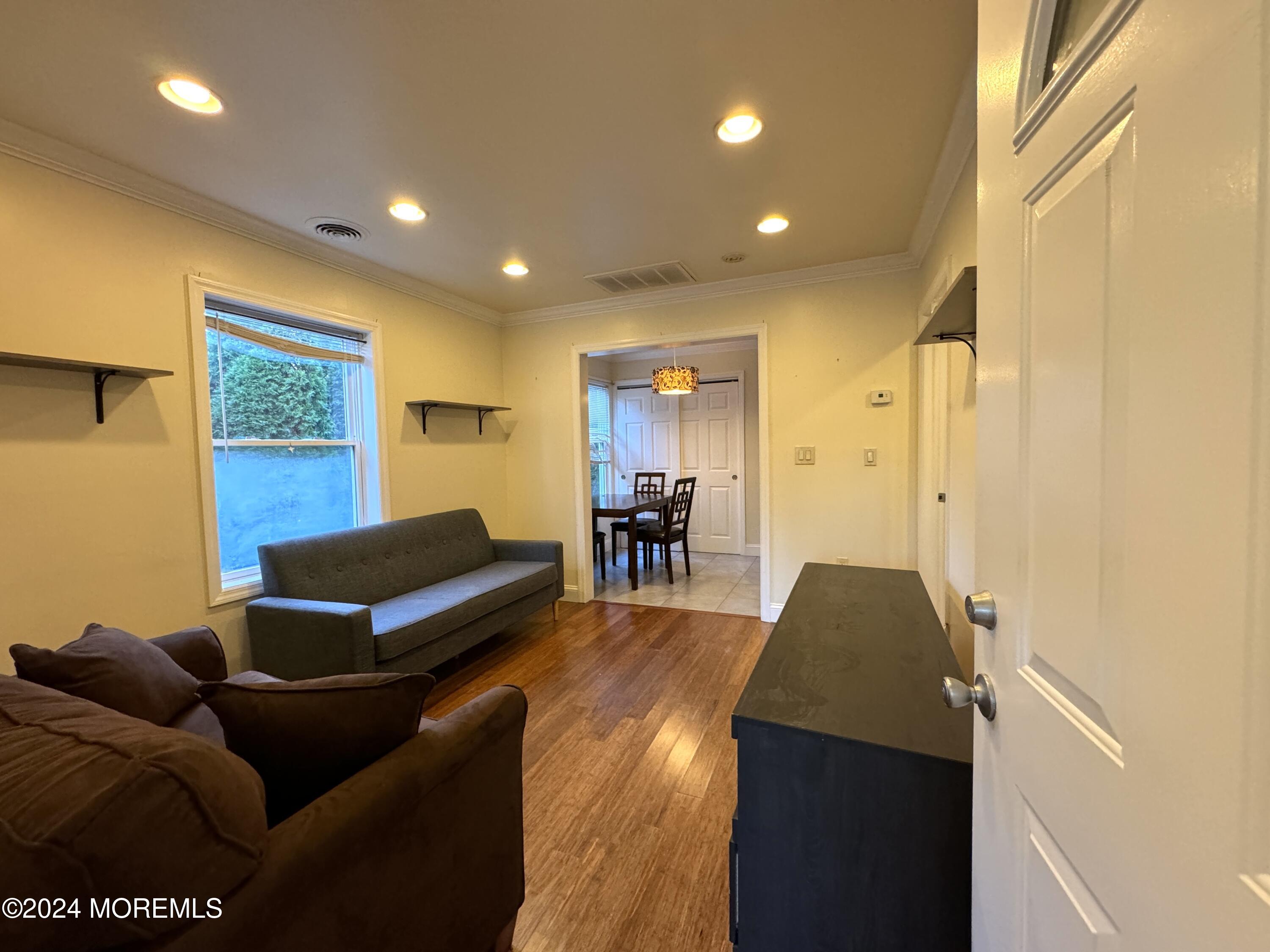 340 Elberon Boulevard, Unit REAR HOUSE Oakhurst, NJ 07755 - Photo 3 of 5 a living room with furniture and a wooden floor
