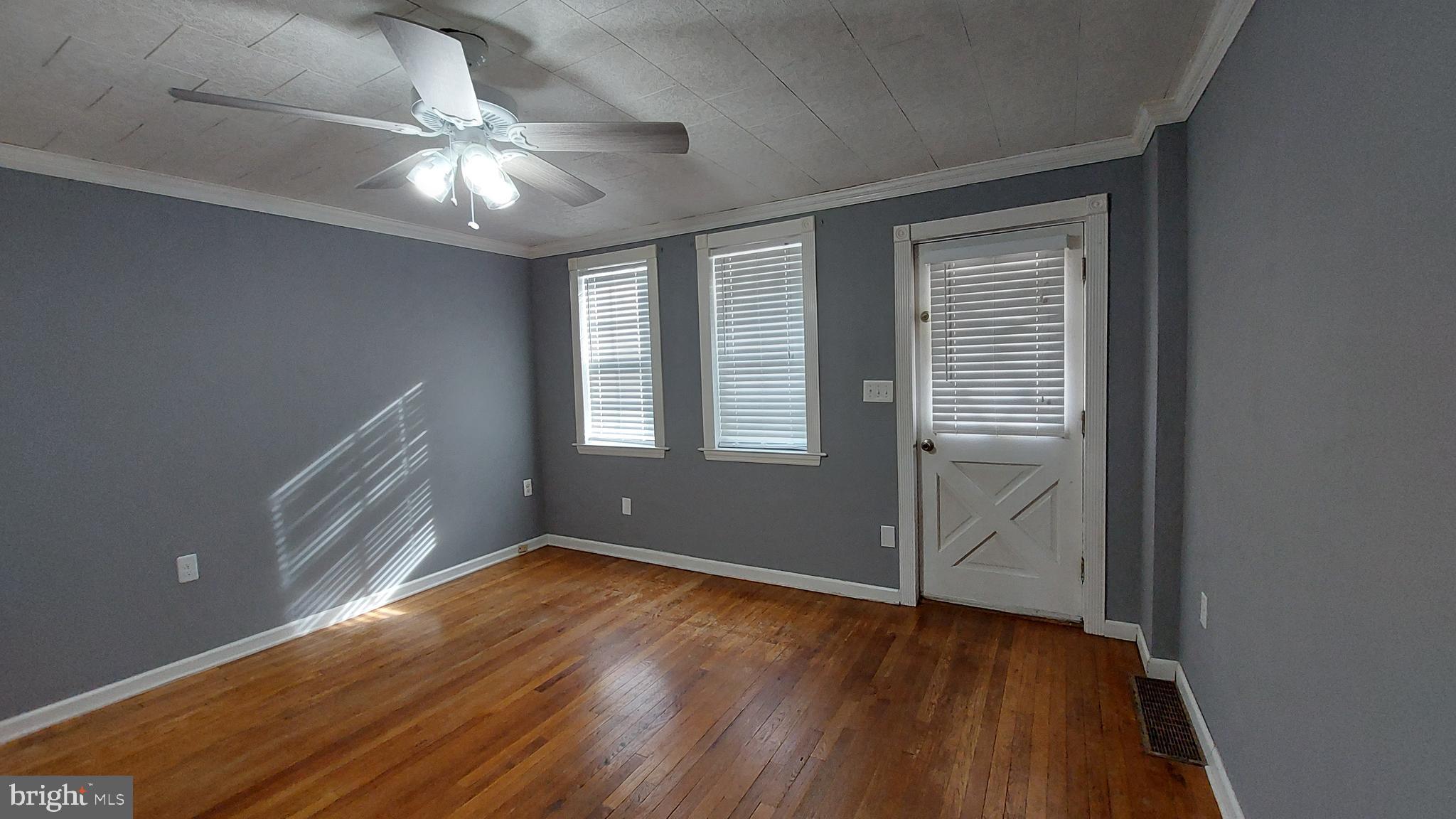 1666 Mussula Road Towson, MD 21286 - Photo 2 of 21 an empty room with wooden floor fan and windows