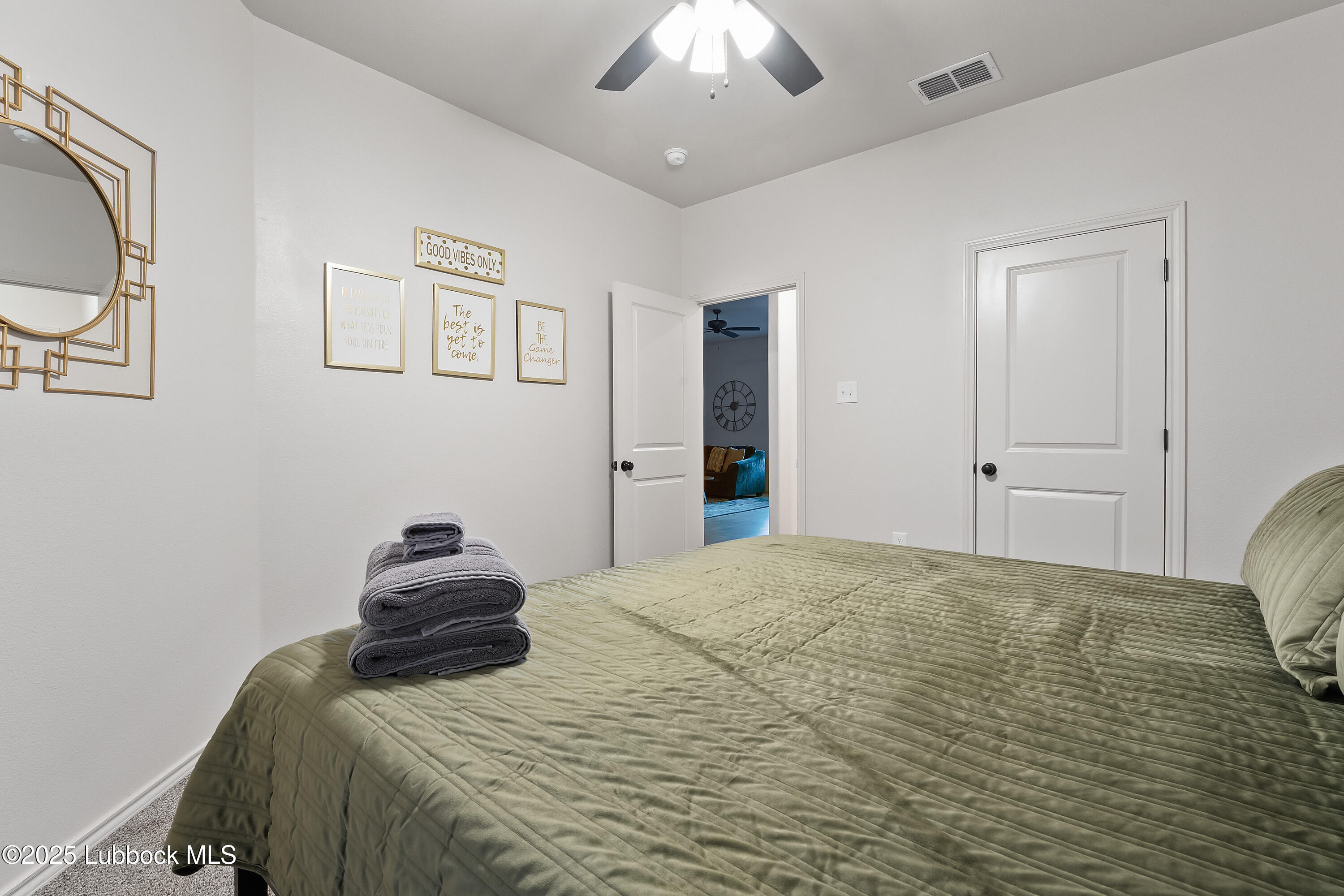 5526 Lehigh Street Lubbock, TX 79416 - Photo 16 of 23 a bedroom with a bed and a chandelier