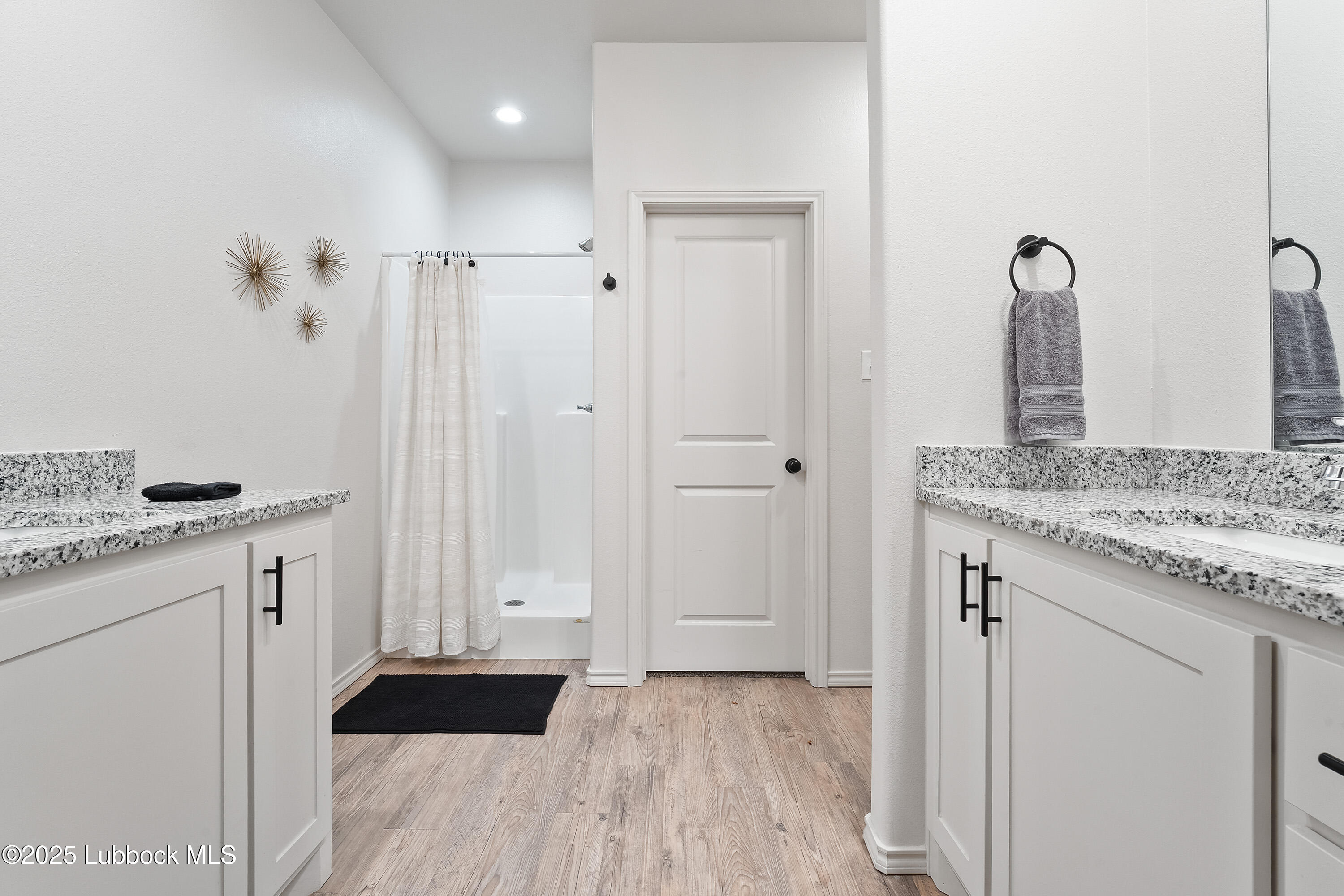 5526 Lehigh Street Lubbock, TX 79416 - Photo 20 of 23 a bathroom with a granite countertop sink and a mirror