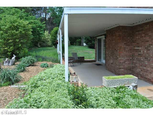 8704 Sweetmeadow Road Colfax, NC 27235 - Photo 14 of 16 Patio/Deck. Covered patio if you prefer a shady place to sit.