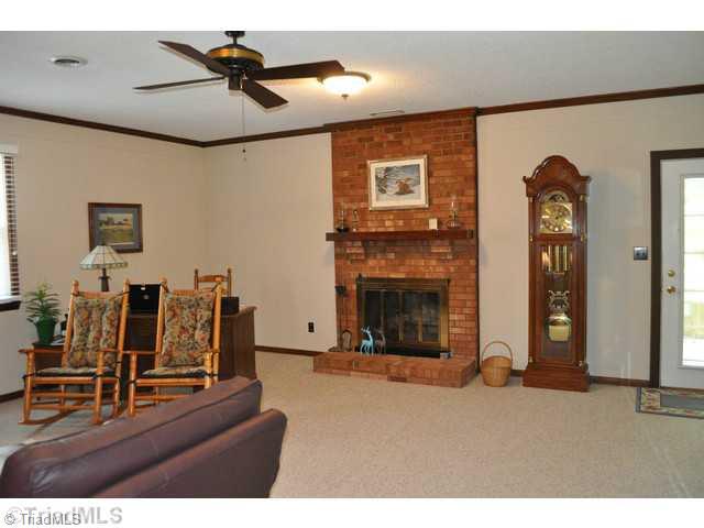 8704 Sweetmeadow Road Colfax, NC 27235 - Photo 3 of 16 Den/Family/Great Room. Over sized den with fireplace - opens onto covered patio.